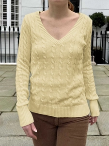 Women's pale yellow V-neck cable knit sweater with long sleeves and ribbed cuffs
