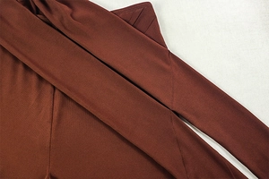 Détail du tissu en maille élastique rouge-brun avec coutures et découpes de qualité