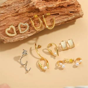 Elegant French style pearl earrings set with gold and silver heart and geometric designs