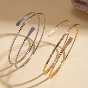 Minimalist double layer open cuff bracelet in gold and silver finish with hammered ends