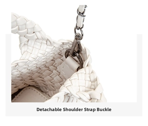 Close-up of detachable silver metal buckle and strap link on white woven bucket bag