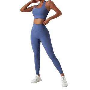Women's two-piece yoga set featuring a misty blue halter sports bra and high-waisted leggings