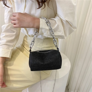 Chic black rhinestone cylinder pillow bag with silver chain straps and shoulder carry