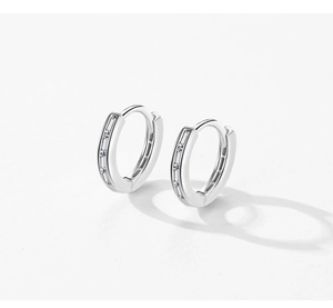 Detail of silver S925 sterling silver hoop earrings with pavé cubic zirconia inlay
