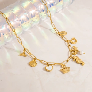 Gold-plated paperclip chain necklace with sea shell, fish tail, and heart charms