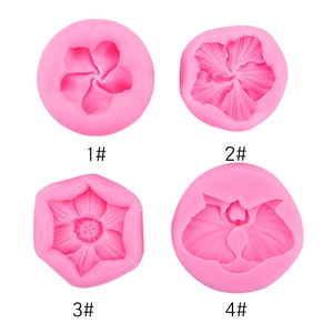 Macro detail of four floral silicone mold patterns for fondant and clay baking crafts