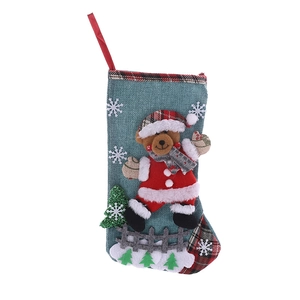 Large Christmas stocking with bear applique, plaid details, and hanging loop on white backdrop