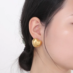 Minimalist gold hollow heart earrings for women made of shiny stainless steel