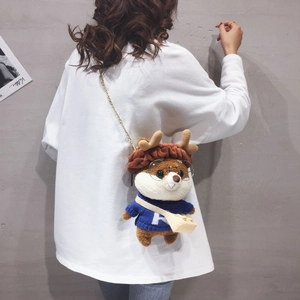 Cute Shiba Inu plush crossbody bag with reindeer hat and gold chain strap on model