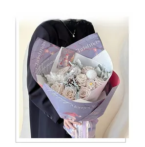 Close-up of bouquet wrapping paper featuring cute snowman patterns and Merry Christmas text