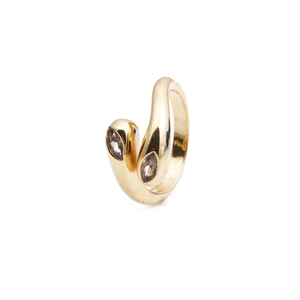 Detail view of a gold snake ring with marquise-cut zircons on a white background