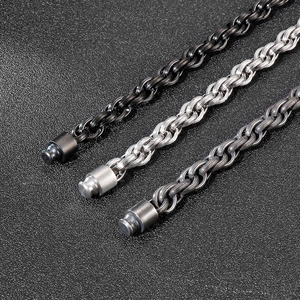 Detail view of punk style wheat chain bracelets in black, silver, and gunmetal finishes