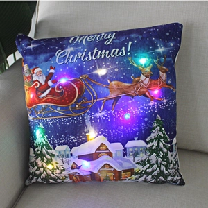 Detail view of LED Christmas pillow featuring Santa and reindeer over a snowy village