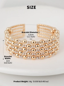 Detailed view of wide gold layered stretch bracelet with rhinestones and beads