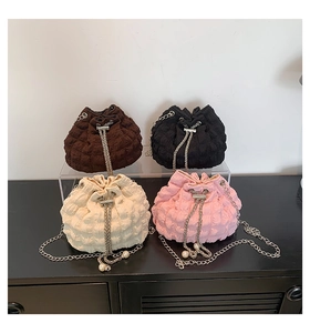 Detail of four colorful drawstring bucket bags with chain straps and pearl accents