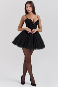 Detailed view of the mesh stitching and pleated corset bodice on this black mini dress