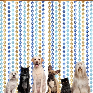 Close-up of gold and blue pet paw print tinsel curtains for party background decoration