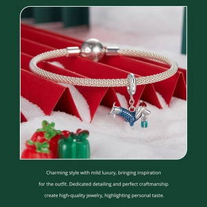 Detail of silver S925 dachshund charm with Christmas hat and blue enamel sweater