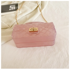 Detail of pink transparent jelly bag with quilted texture and gold chain strap