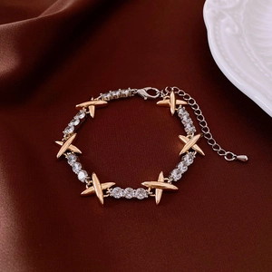 Detailed close-up of 18k gold plated cat eye opal bracelet on dark brown silk fabric