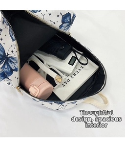 Interior view of white canvas backpack showing capacity for water bottle and umbrella