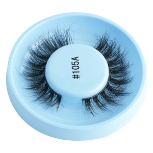 Macro shot of 105A thick curly false eyelashes on a light blue round plastic tray