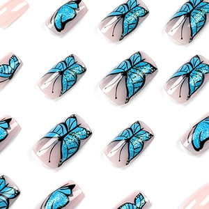 Blue glitter butterfly press on nails with squoval shape and natural nude base color