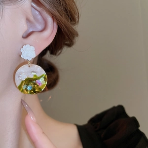 French vintage floral drop earrings with butterfly and crystal accents on a model