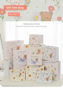 Detailed stacked view of floral cartoon bear gift bags with woven rope handles