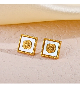 Close-up of golden square earrings with embossed rose pattern and beaded edge detail