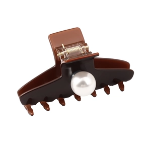 Elegant dark brown hair claw clip with a large pearl accent and golden metal spring