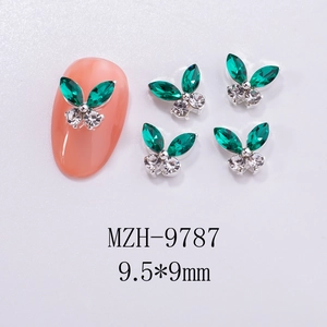 Detail of 3D butterfly nail charms with green rhinestones and 9.5x9mm dimensions