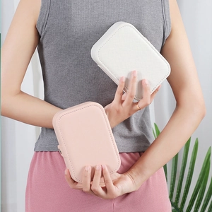 Portable PU leather jewelry organizer boxes in cream and pink shown by a model