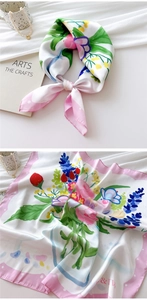 Detailed shot of 70cm silk square scarf with hand-painted floral patterns and pink polka dot edges
