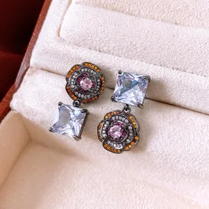 Vintage-style asymmetric flower earrings with colorful zircon stones in dark metal base