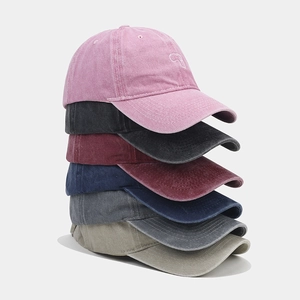 Detailed stack of vintage washed cotton baseball caps showing assorted colors and texture