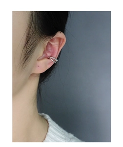Close-up of minimalist double-layer silver ear cuff worn on the ear cartilage