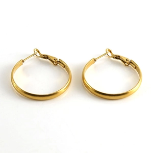 Detailed view of polished gold stainless steel hoop earrings with classic clasp design