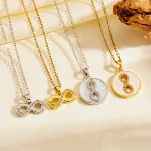 Detailed view of infinity necklaces with sparkling zircons and mother of pearl on satin