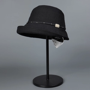 Detail of black Japanese paper weave sun hat with metallic studs and crystal decoration