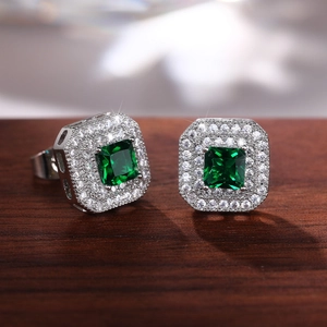 Macro detail of classic square green zircon earrings with double white crystal halo finish