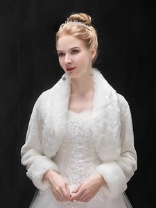 Close-up of elegant white faux fur bridal shawl with soft texture and refined wedding style