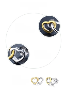 Detail of S925 sterling silver heart earrings with 18K gold plating and manual polish