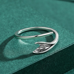 S925 sterling silver open ring with adjustable dolphin tail design on green background