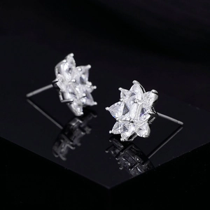 Sparkling S925 sterling silver snowflake stud earrings with zircon on black mirror
