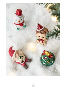 Detailed view of miniature Christmas figurines including Santa and snowman on snow