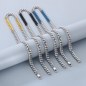 Detail showing four two-tone Cuban necklaces in silver, gold, black and blue stainless steel
