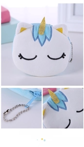 Detail of embroidered eyes, gold horn, and metal bead chain on unicorn plush coin purse