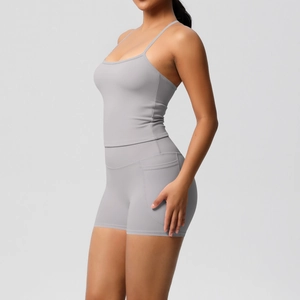 Detail of grey yoga set featuring high-waist fitness shorts with side pockets and a tank top