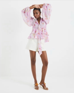 Detail of French style purple floral chiffon top with ruffle trim and tie neck design